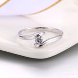 Ring with Curved Bar in Silver and Sparkling Diamond in the Center