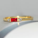 Central red stone with a shiny gold ring