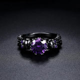 Retro black round ring with a beautiful purple stone and intricate design